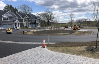 Lexington, Massachusetts - Community asphalt circle with curbs and brick pavers.
