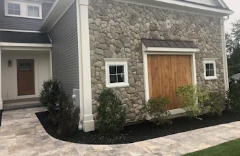 Groton, Mass - Stone veneer on face of house and columns with blue stone cap and tile.